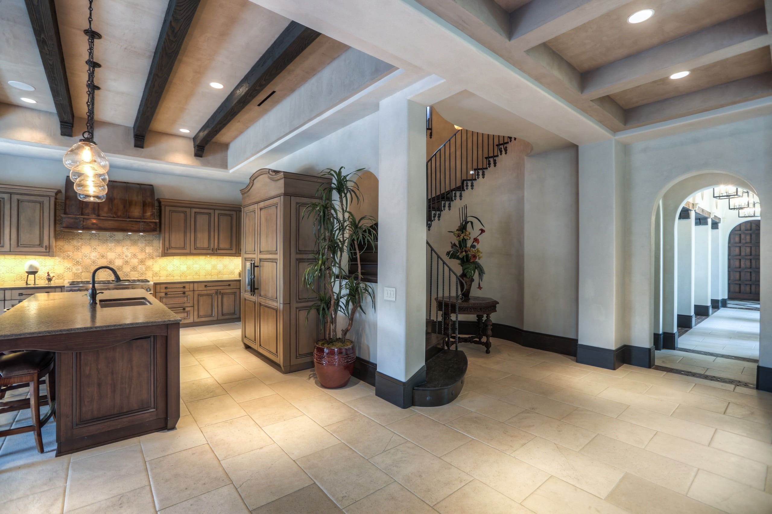 Spacious kitchen and hallway with staircase.