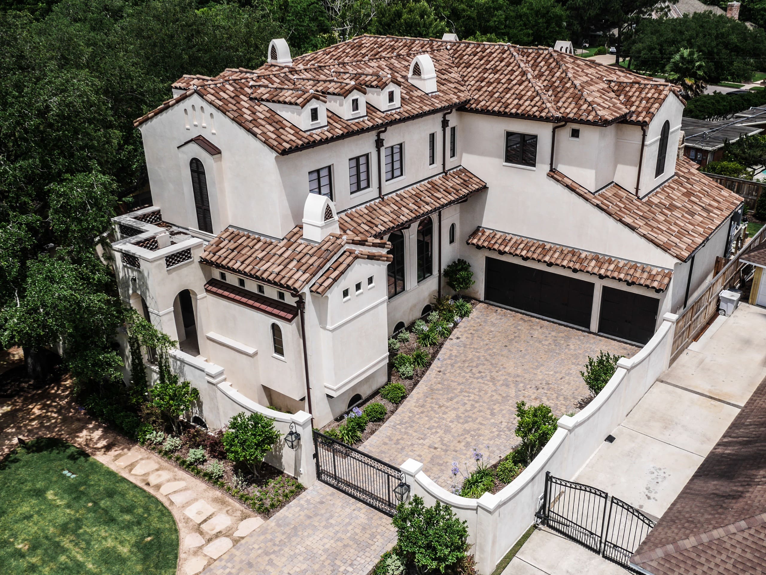 Large Mediterranean-style house with tiled roof.